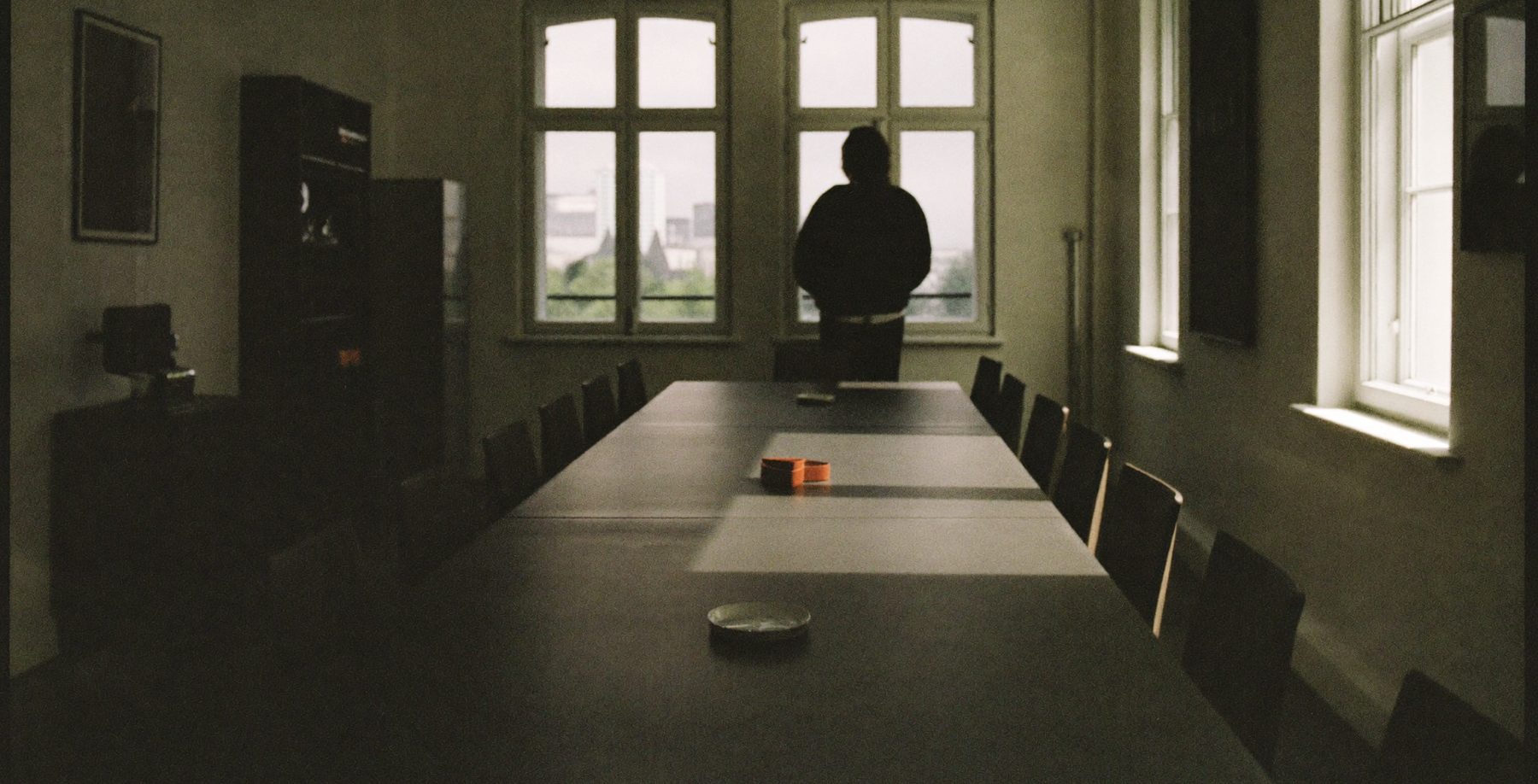 An empty boardroom in early morning light.